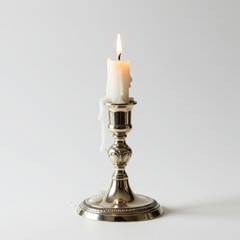 Burning candle in a silver candlestick isolated on white background. for decoration, meditation, or memorial.