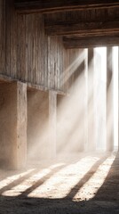 Sunbeams illuminate a dusty, concrete and wood-paneled interior space, creating dramatic light and shadow patterns on the ground