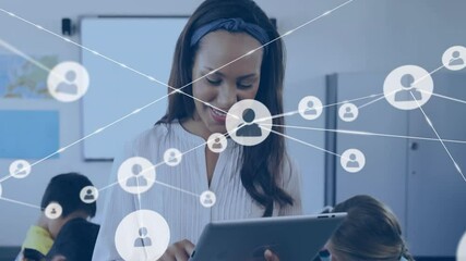 Classroom teacher tapping tablet activating network icons illustrating student connectivity - Powered by Adobe