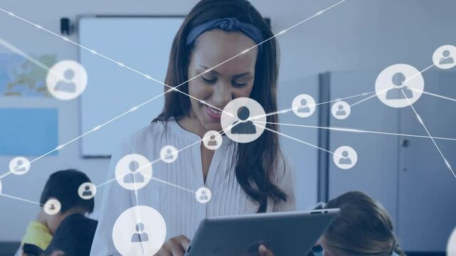 Classroom teacher tapping tablet activating network icons illustrating student connectivity - Powered by Adobe