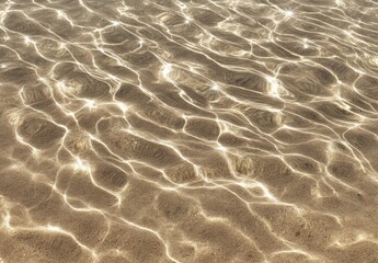Sunlight patterns dance on a sandy seabed, creating rippling light and shadow effects through shallow, clear water