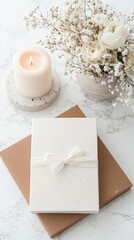 White Textured Brochure with Ribbon and Flowers Flatlay