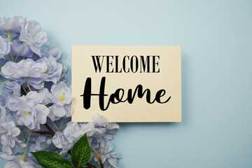 Welcome Home text with flowers decoration on light blue background