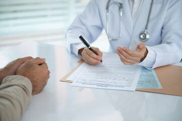 Male doctor discuss with patient for gives medical information  diagnose and treatment guidelines by patient-centered care.
