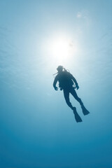 dynamic portrait of underwater hunter positioned on right side of frame hands out of view