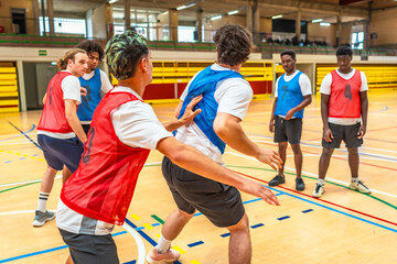 Basketball players competing during training in a gymnasium