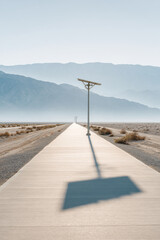 minimalistic photograph of solar panel casting long shadows on solar energy farm in usa