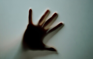 Marco hand waving behind frosty
glass.Female ngers sliding on glass
surface indoors. Abstract...