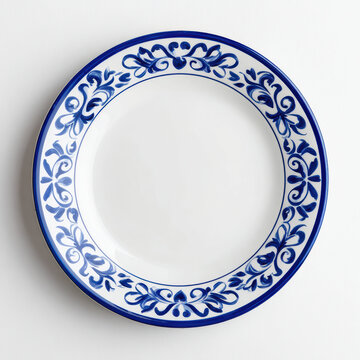 Decorative white ceramic plate with blue floral pattern on white background