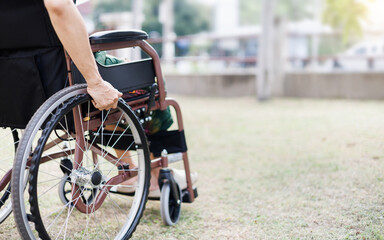 Obraz premium cropped shot, middle age female on wheelchair on grass field at home she resting after being sick