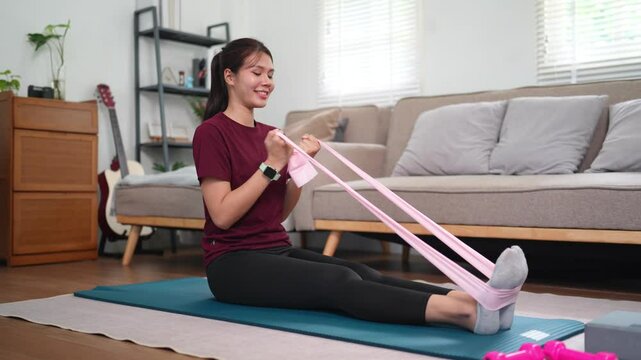 Asian woman practicing resistance band hamstring and calf stretch, improving leg flexibility and posture