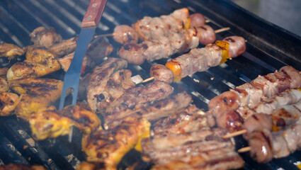 finishing touches to the almost cooked meat while everyone waits with their mouths watering