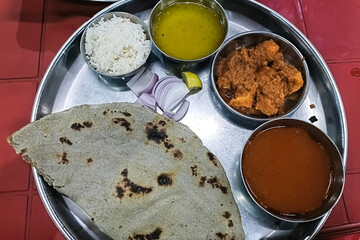 chicken tikka masala spicy curry meat food in a plate with rice and naan bread
