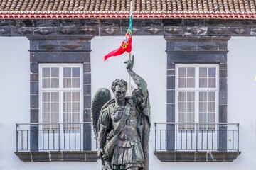 Majestic Archangel Statue With Portuguese Flag Against City Hall, Municipal Historic Building....