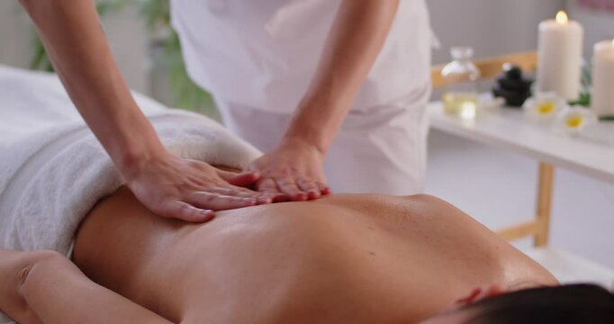 Relaxing female organic aromatics massage oil pleasure, stimulating skin health, massage therapist doing massage, spa shoulder, back care, relax muscles, energising body, therapeutic beauty treatment