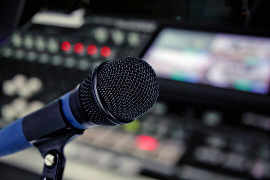 Close-up microphone with audio mixer background for instrument feedback sound check or live podcast and producer broadcasting studio.