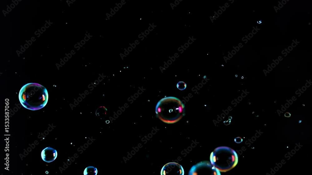 Poster an enchanting display of colorful bubbles floating gracefully against a black background