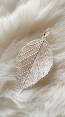 Delicate Silver Leaf Pendant on Soft White Fur with Natural Light for Luxury Jewelry Display