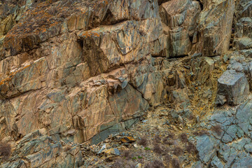 Rugged rock formation in desolate mountainous region during daytime