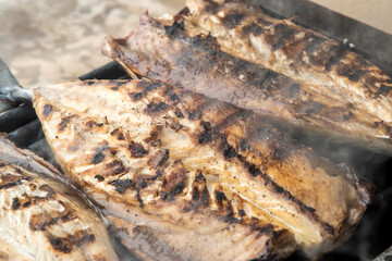 Grilled mackerel fish fillets on the grill. Close-up.