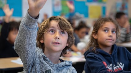 Fototapeta premium Young students raising hands in bright classroom during lesson 