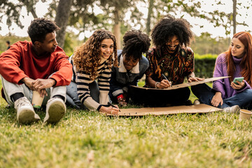 Young activists preparing protest signs in park