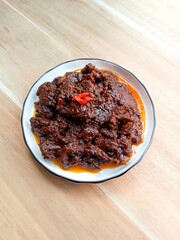 Beef rendang, a flavorful and spicy meat dish originating from the Minangkabau region of West Sumatra, Indonesia. Popular dishes