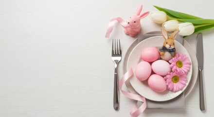 Easter table setting with pink eggs bunny flowers tulips and silverware on a white background surface