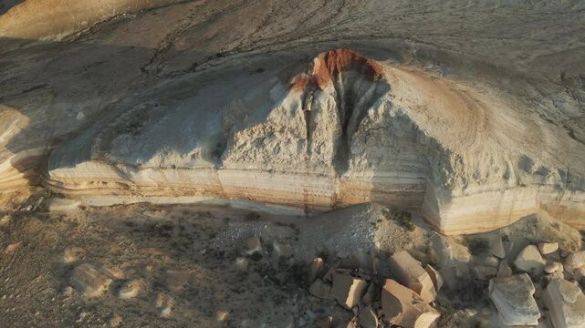Aerial view of dramatic erosion crater and broken cliffs in Aktumsuk, Uzbekistan