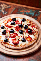 Pizza with salami and mozzarella cheese, jalapeno pepper and black olives. Wooden background. Soft focus. Close up.	