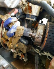The old and dirty engine of the car is in disrepair.