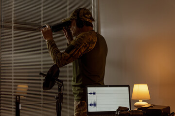 A modern scout or agent's workstation with surveillance and recording equipment.