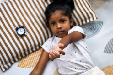Child reaching out for help from a cozy bedroom setting