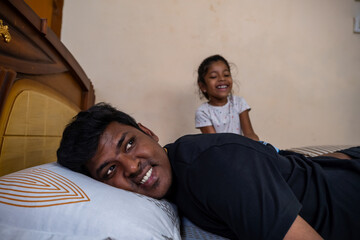 Father and daughter sharing joyful moments at home