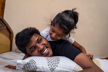 Father and daughter share a joyful moment at home