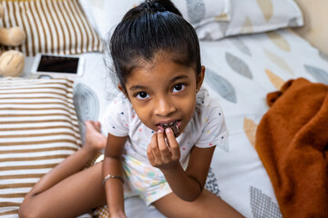 Girl enjoying a chocolate snack at home during the afternoon