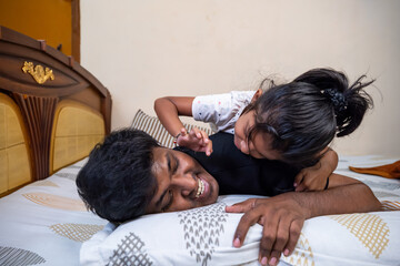 Father and daughter enjoying playful moment at home