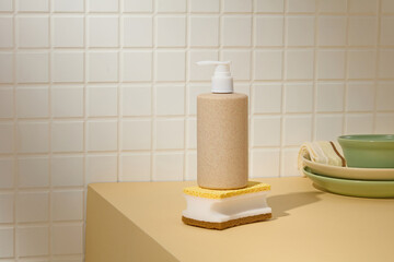 A modern liquid soap dispenser and cleaning pads sit on a countertop with tiled walls, emphasizing simplicity and everyday cleaning habits.