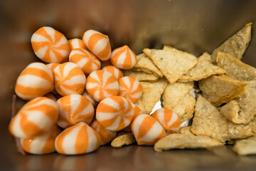 Metal trays filled with various fresh food ingredients in a buffet display, including meat, seafood, and assorted processed items