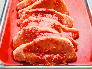 Fine pork chops in rich red juicy marinade. Raw meat product for cooking in many different way....
