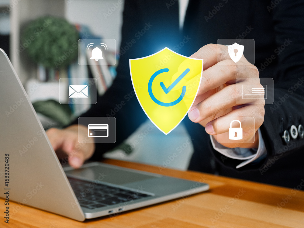 Poster a person in suit interacts with laptop displaying digital security icons including shield with check
