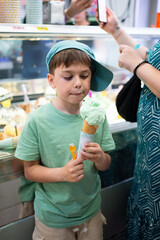 Boy enjoying refreshing ice cream cone at gelato shop