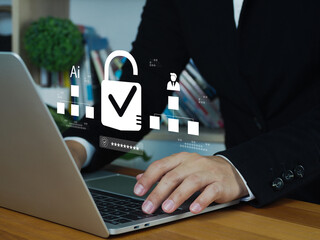 Businessman working on laptop with digital security lock icon and AI data visualization, symbolizing cybersecurity and data protection in professional setting