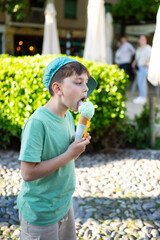 Boy enjoying refreshing mint ice cream on a sunny day