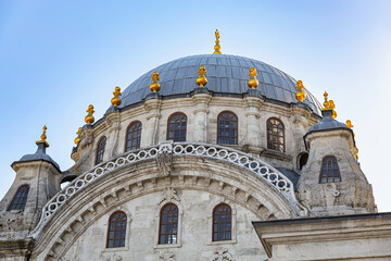 Nusretiye Mosque, Istanbul. Close-up of the dome, showcasing Ottoman baroque design and golden finials under clear sky. Turkey (Turkiye)
