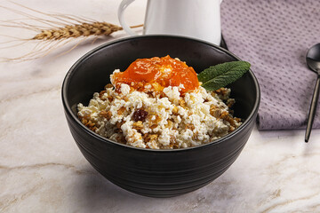 Curd with granola and orange jam