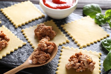 Making ravioli bolognese at wooden table, closeup