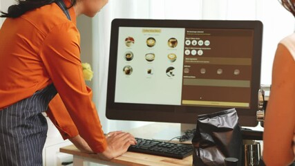 A young Asian female barista in modern cafe assists woman customer ordering latte, fresh coffee beans, dark roast, croissant, completing the purchase with mobile payment at the POS using QR code. - Powered by Adobe