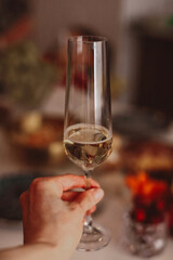 Female hand holding a glass of champagne