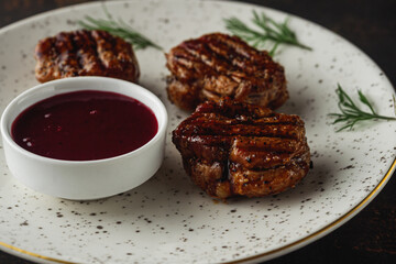 Grilled pork medallions steaks, tenderloin fillet with berry sauce. Ready to eat.